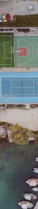 aerial-view-of-sports-courts-and-boats-by-the-sea.jpg Aerial view of sports courts and boats by the sea